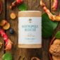 Flacon de complément alimentaire Nootropique Booster UNAE, 60 gélules, entouré de plantes, racines et noix sur fond en bois.